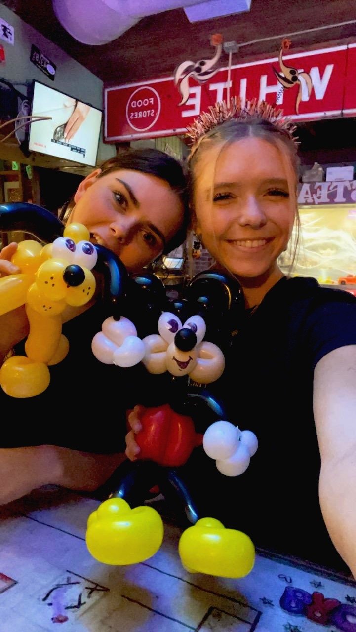 women with balloons at restaurant family night event