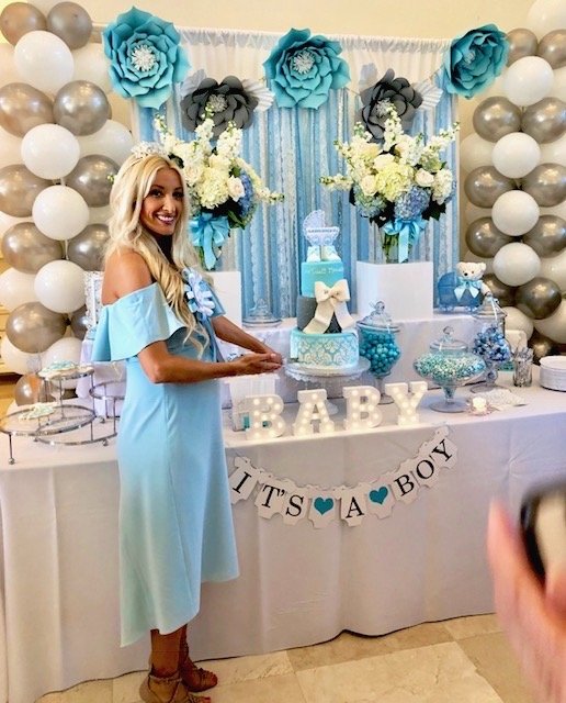 Organic balloon arch installation at a baby shower