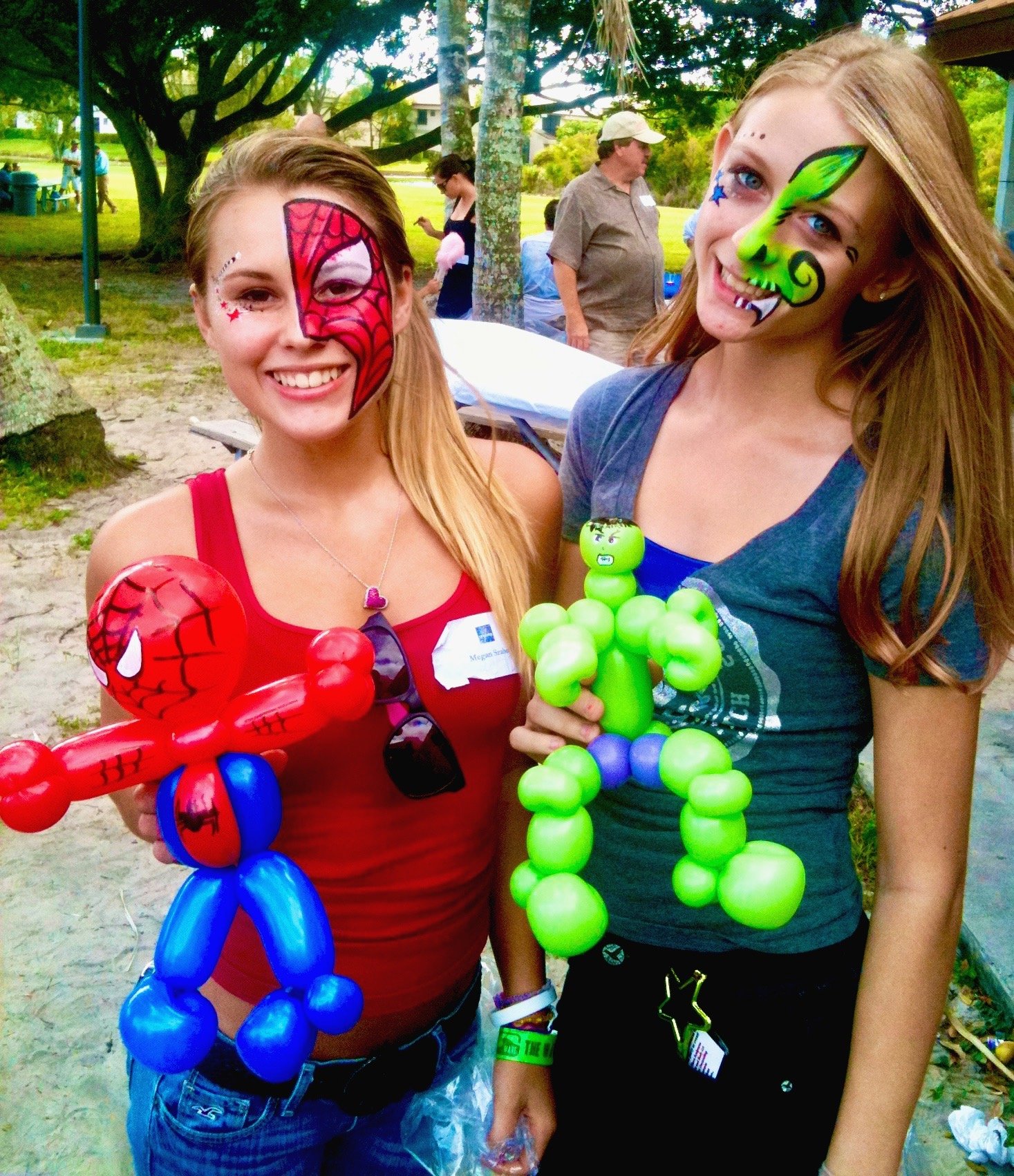 Professional face painter creating colorful designs at a Florida event