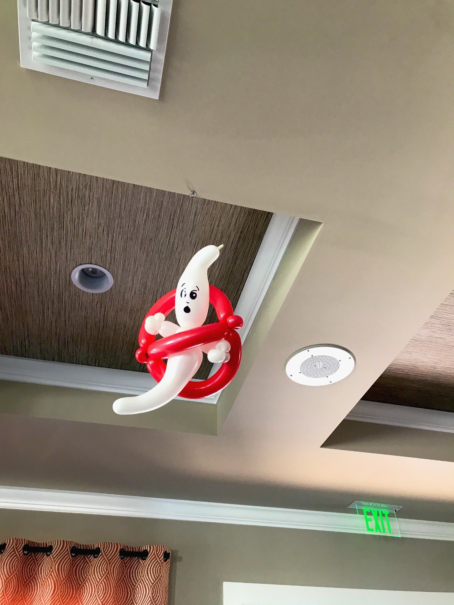 Halloween ceiling balloon ghost installation as part of a holiday decor package